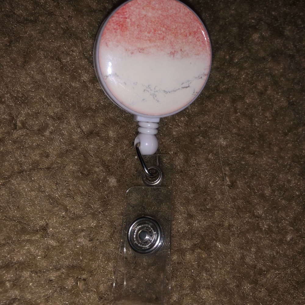 pink and white badge clip